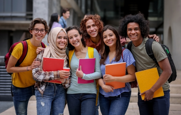 a group of students stand in a line and smile for a photo