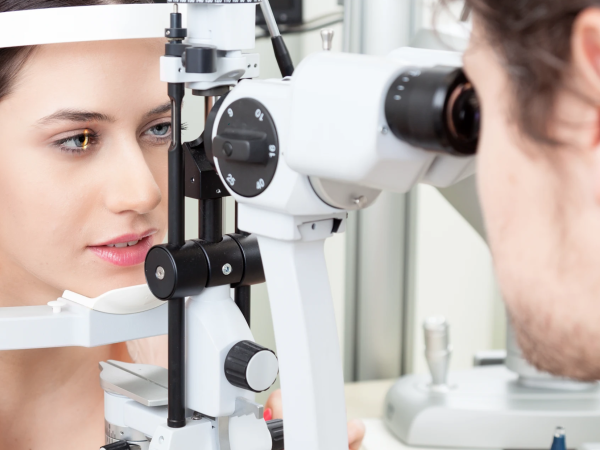 a person gets her eyes looked at by a doctor